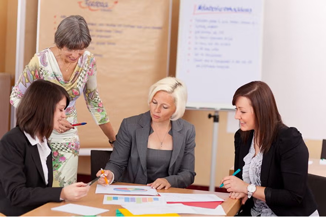 Educational leaders reviewing documents at meeting table