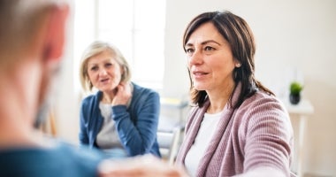 "A counsellor talking to a group in a counselling session"
